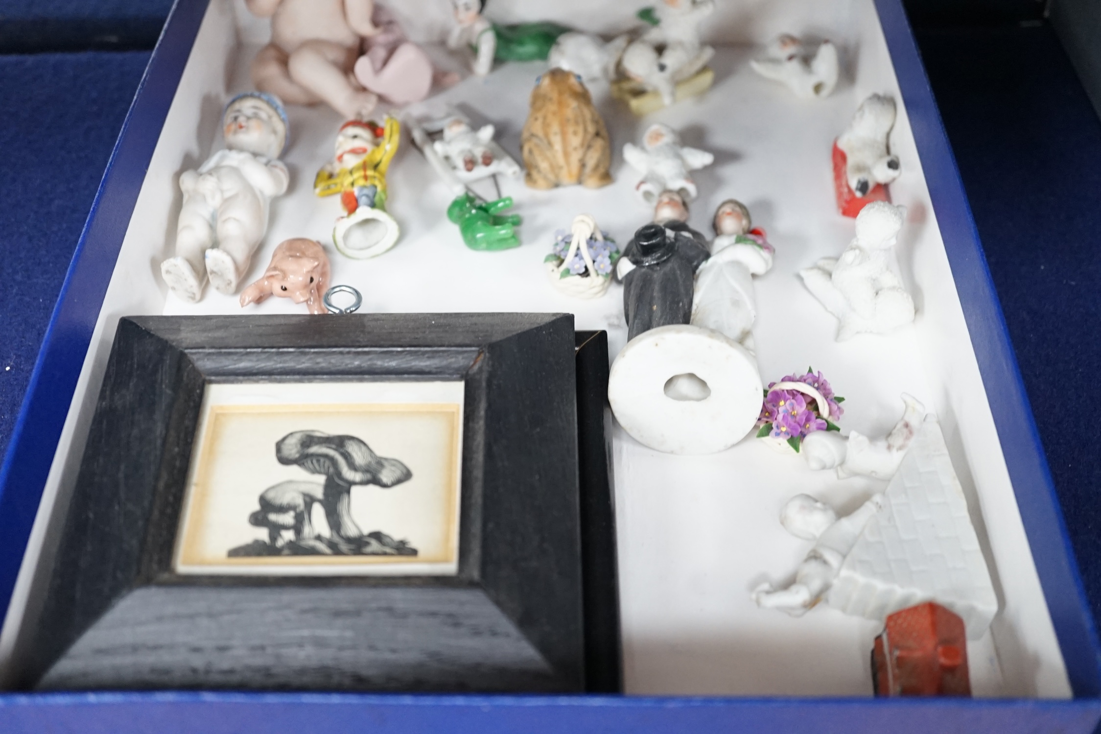 A collection of cabinet curiosities, including miniature cups, an ostrich egg, a Japanese marbled pottery teapot, a sand picture, snowmen cake decorations, etc. (2 trays). Condition - fair to good